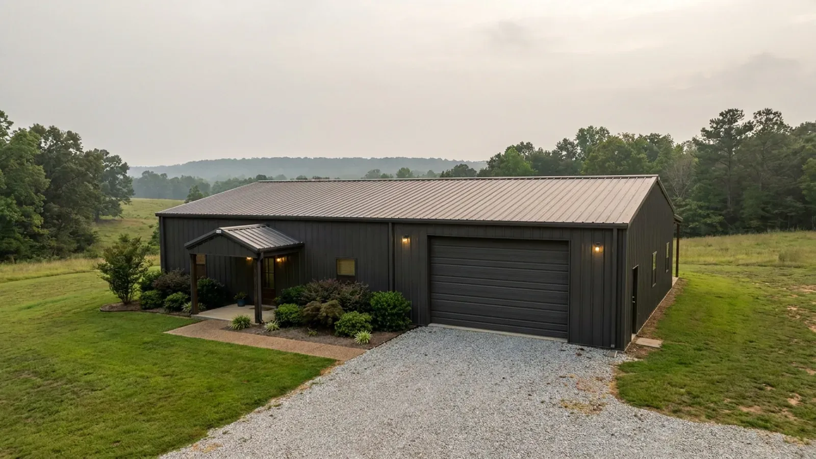 A completed 40x60 barndominium showing a residential entry on one end and a wide shop door on the other under one continuous roof.