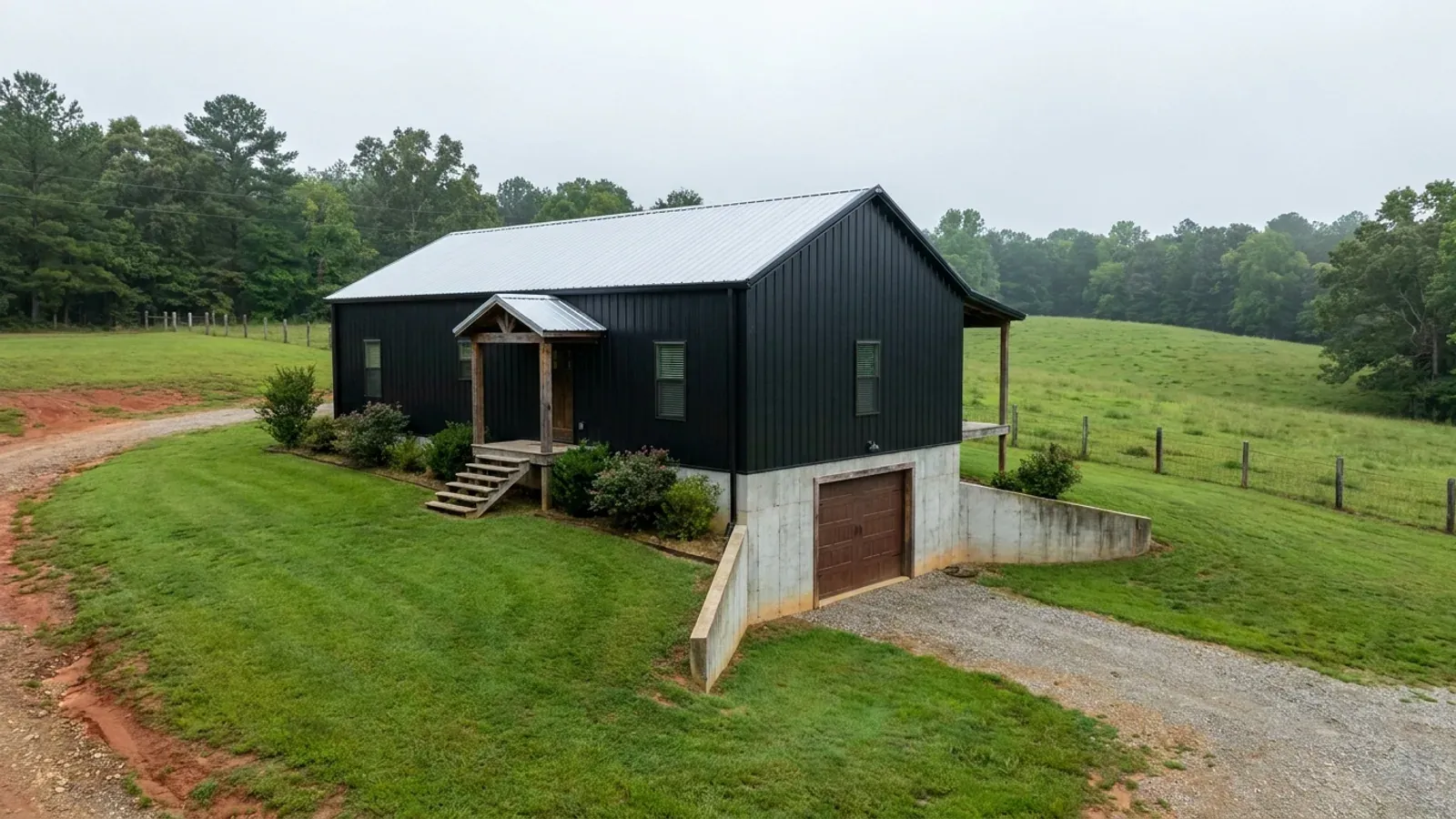 A barndominium raised on a stem-wall foundation with steps up to the entry and enclosed storage space beneath the elevated floor.